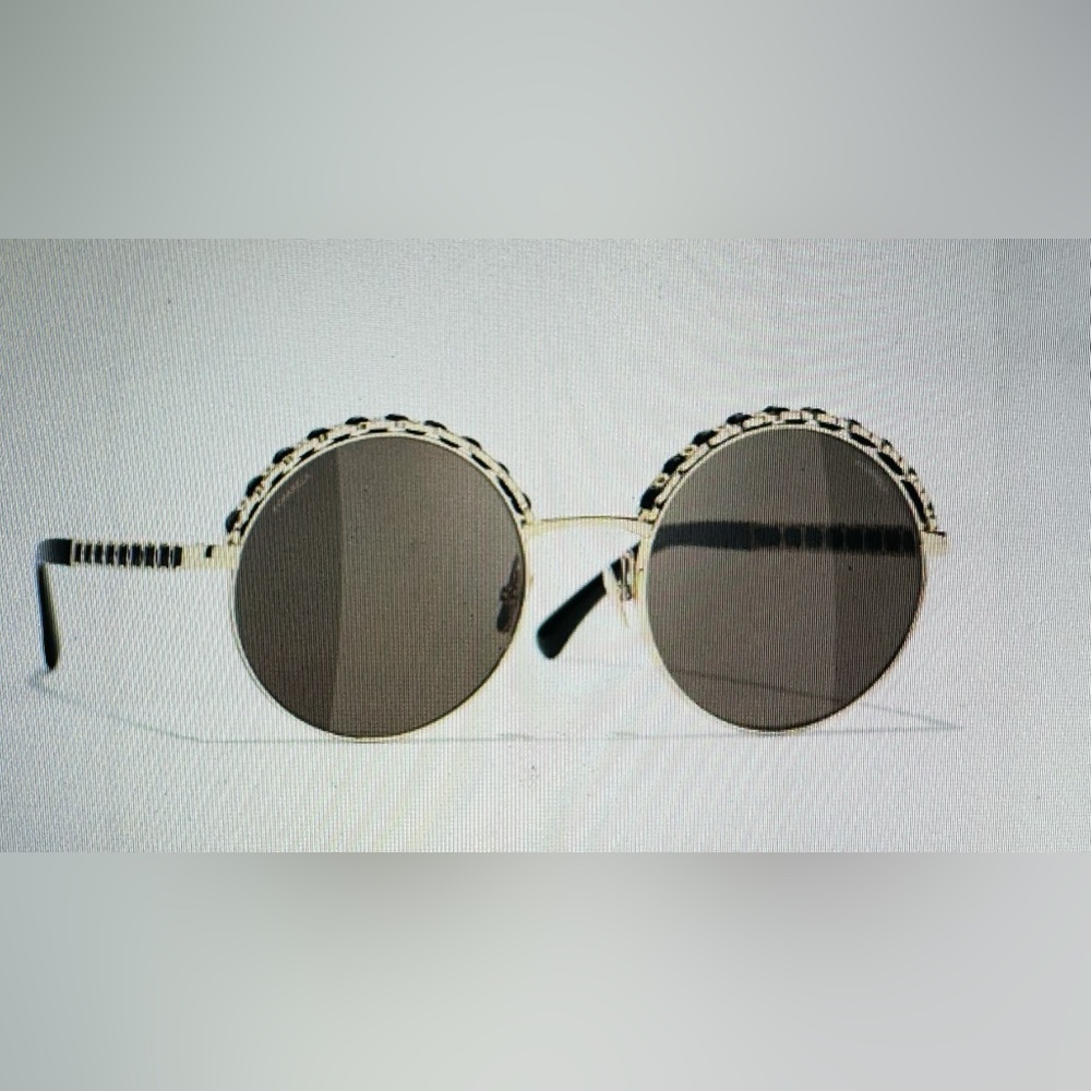 Round metal and calfskin sunglasses w/ gold and black frame and brown lenses.